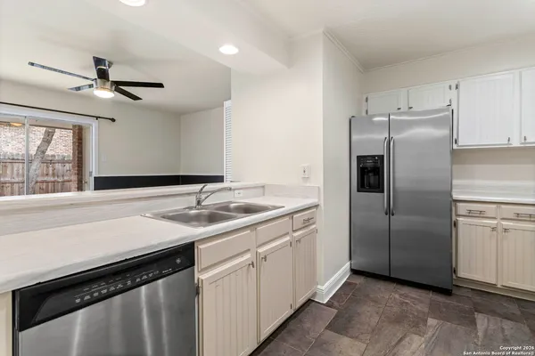 a kitchen with a sink appliances and cabinets