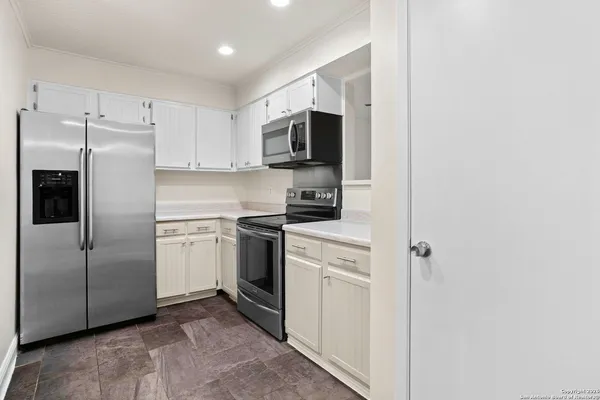 a kitchen with stainless steel appliances a refrigerator sink and microwave