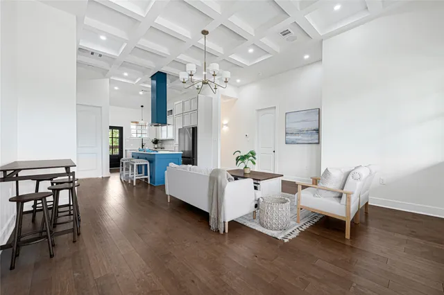 a living room with furniture and wooden floors