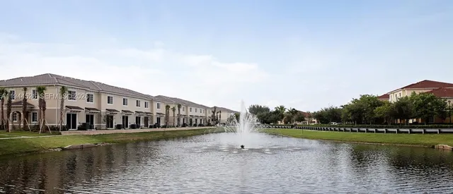 a view of swimming pool with a yard and wooden fence