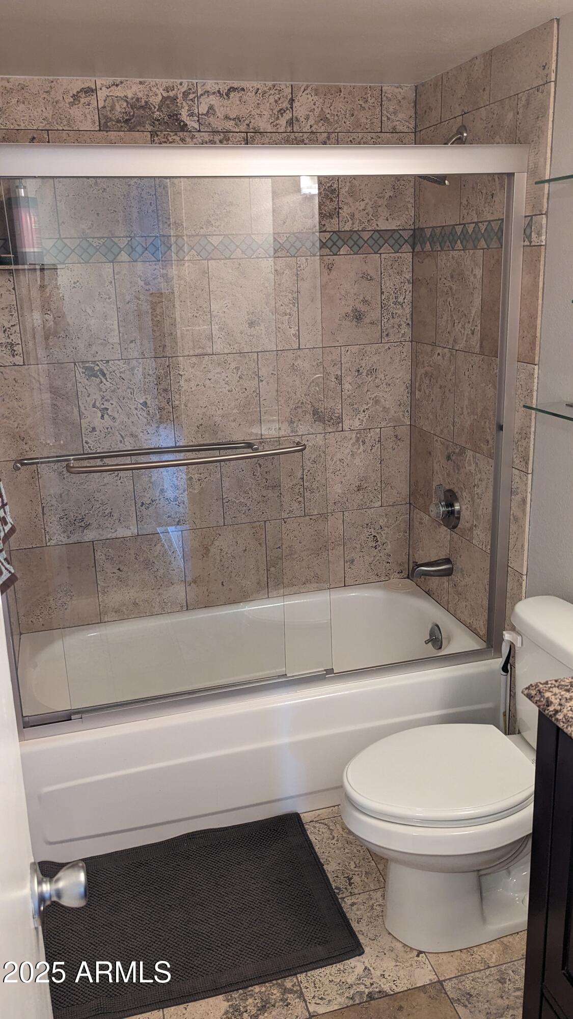 7910 East Camelback Road, Unit 302 Scottsdale, AZ 85251 - Photo 15 of 26 a bathroom with a toilet and a bath tub