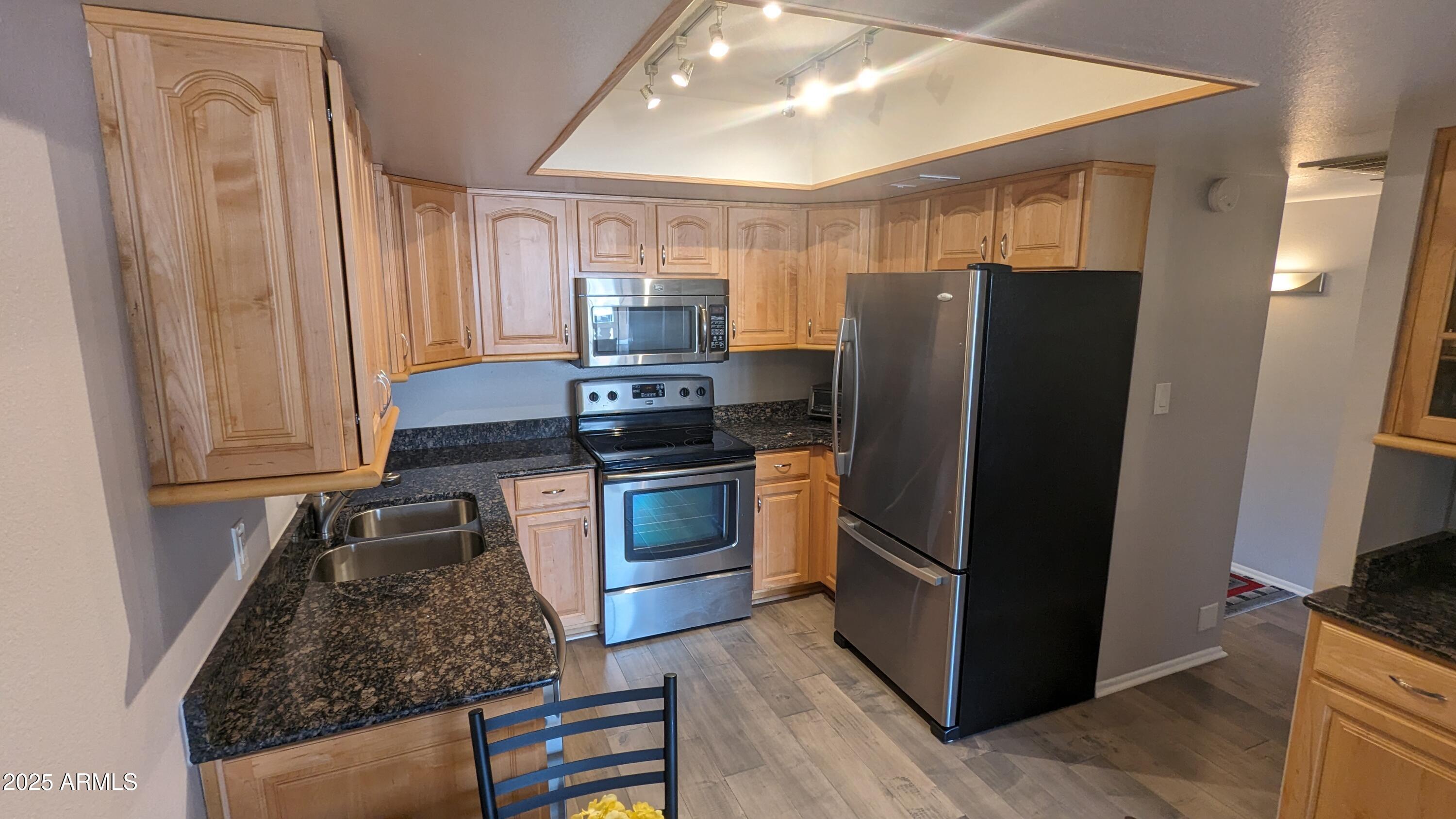 7910 East Camelback Road, Unit 302 Scottsdale, AZ 85251 - Photo 2 of 26 a kitchen with a refrigerator stove and sink