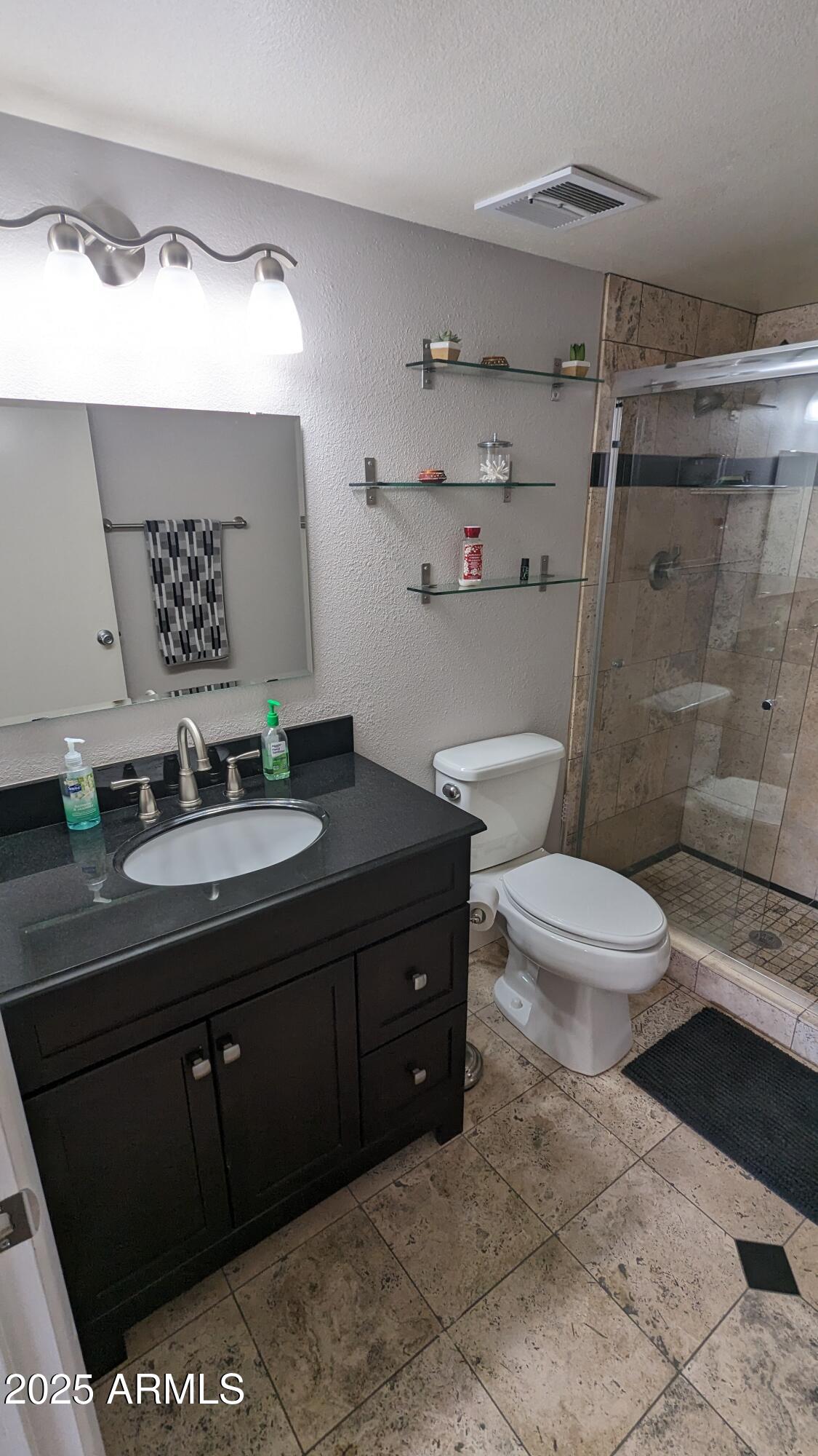 7910 East Camelback Road, Unit 302 Scottsdale, AZ 85251 - Photo 10 of 26 a bathroom with a sink a toilet and shower