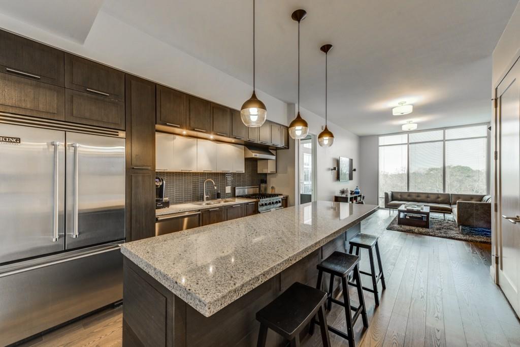 1820 Peachtree Road Northwest, Unit 606 Atlanta, GA 30309 - Photo 1 of 1 a kitchen with stainless steel appliances granite countertop a sink a stove and a refrigerator
