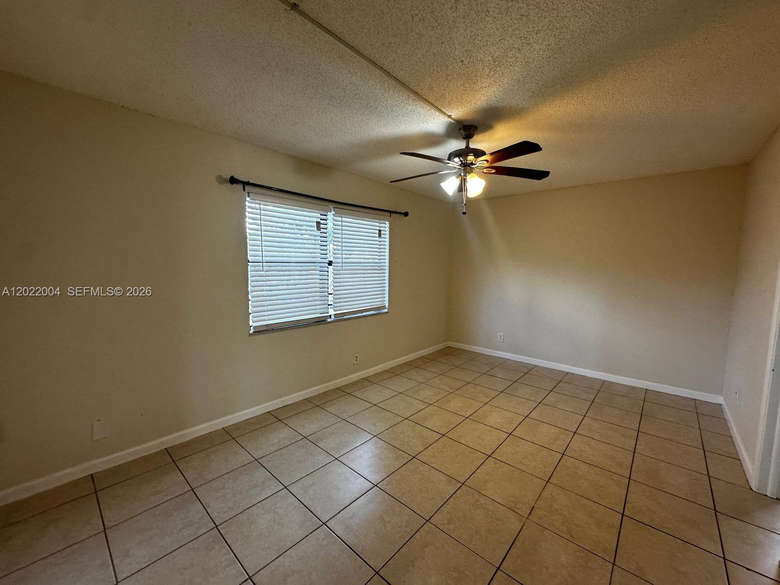 3400 Foxcroft Road, Unit 301 Miramar, FL 33025 - Photo 53 of 72 an empty room with windows and fan