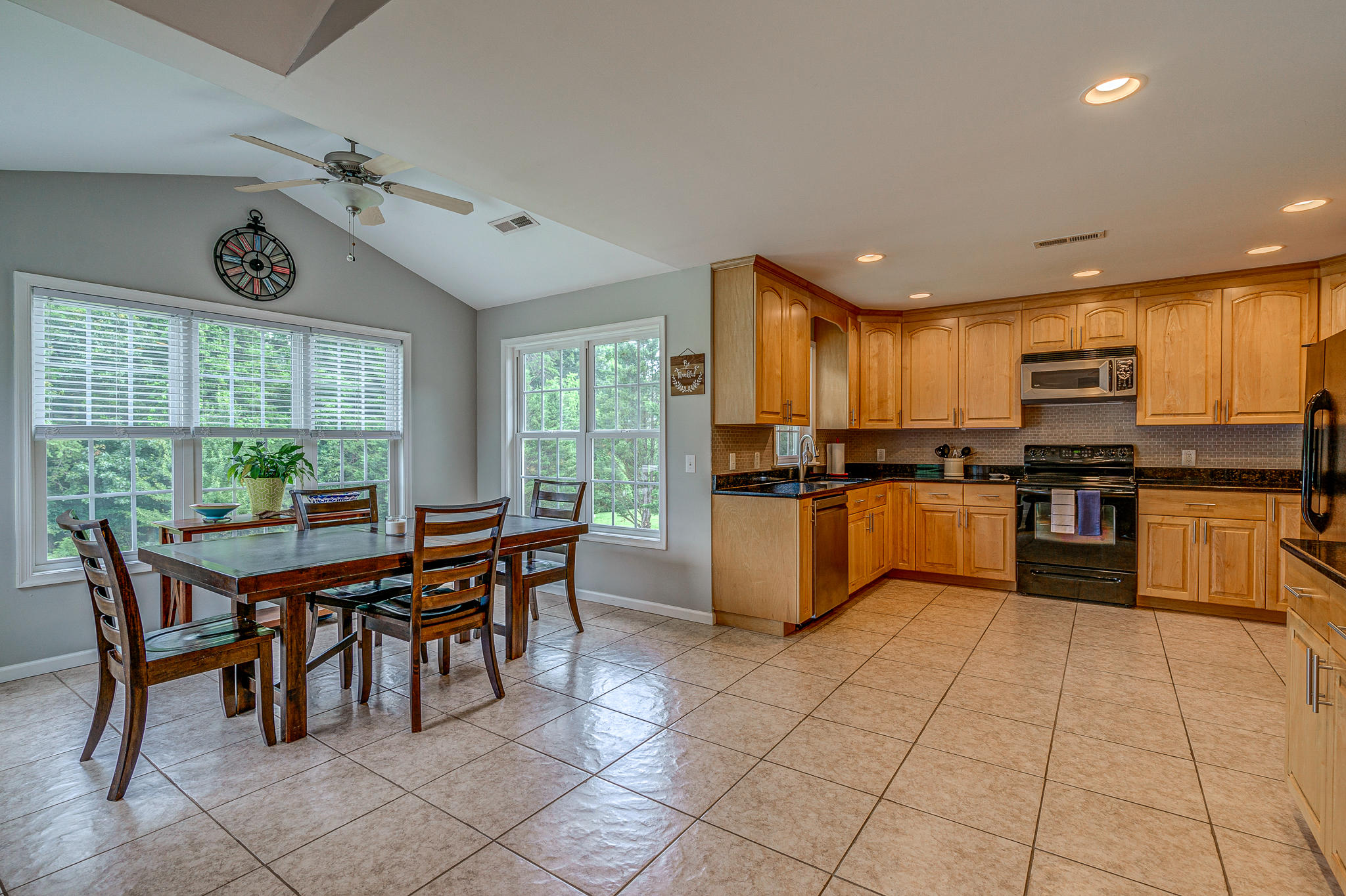 719 Mallard Point Road Wirtz, VA 24184 - Photo 14 of 57 a kitchen with stainless steel appliances kitchen island granite countertop a stove a sink a refrigerator dining table and chairs