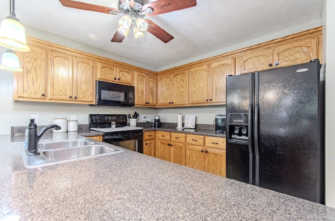 310 Ping Hl Cove Counce, TN 38326 - Photo 14 of 43 a kitchen with stainless steel appliances granite countertop a refrigerator a stove top oven a sink and dishwasher