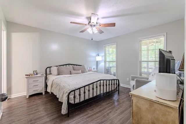 a bedroom with furniture and flat screen tv