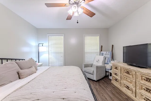 a bedroom with furniture and a flat screen tv