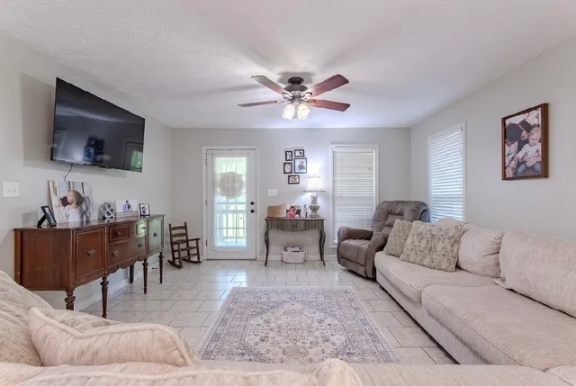 a living room with furniture and a flat screen tv