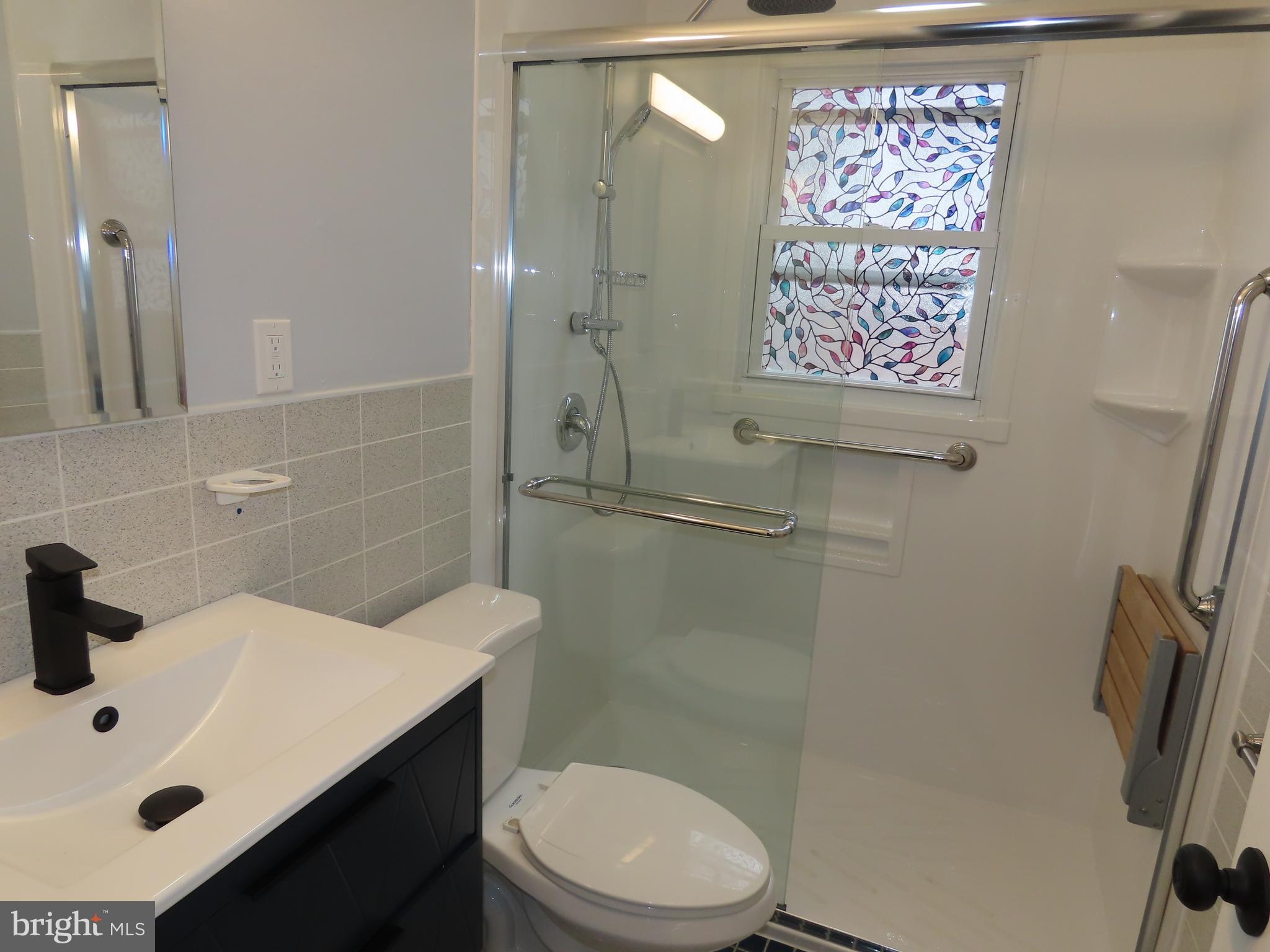 110 Robinson Drive New Castle, DE 19720 - Photo 10 of 10 a bathroom with a sink a toilet and shower
