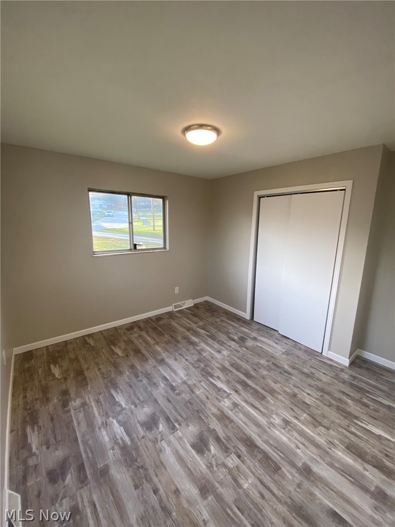 342 Diane Street Rittman, OH 44270 - Photo 11 of 17 Unfurnished bedroom with a closet and dark wood-type flooring