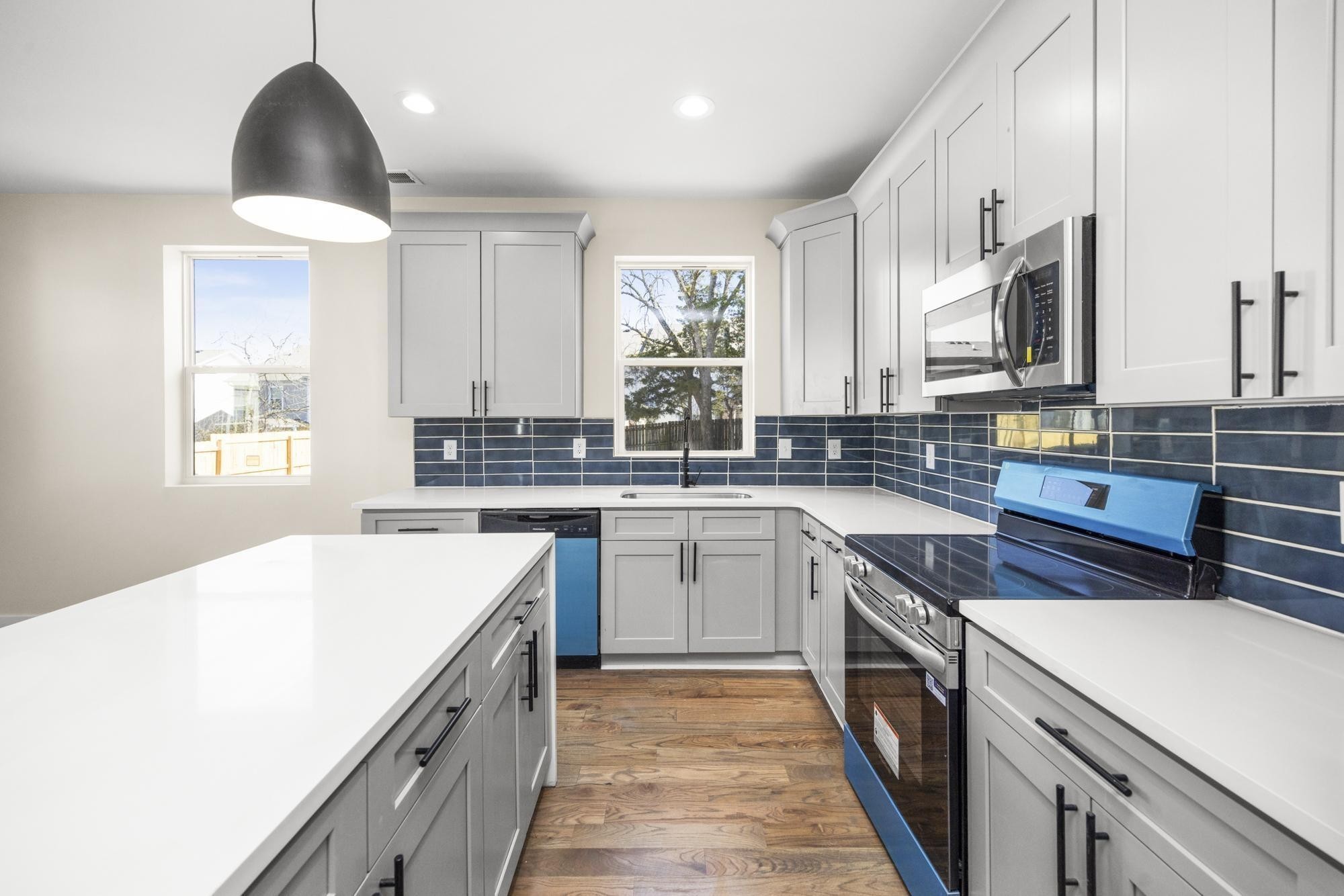 a kitchen with a sink stove and cabinets