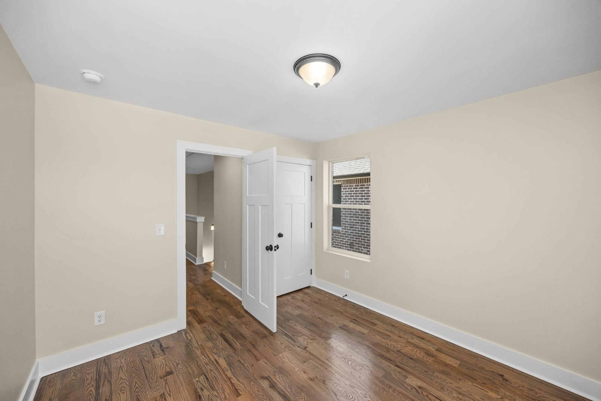 447 Sand Hill Road, Unit 4 La Vergne, TN 37086 - Photo 26 of 27 an empty room with wooden floor and windows
