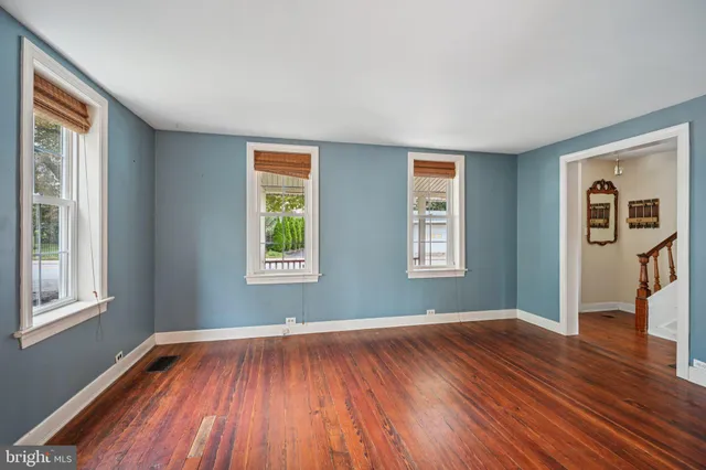 wooden floor in an empty room with a window