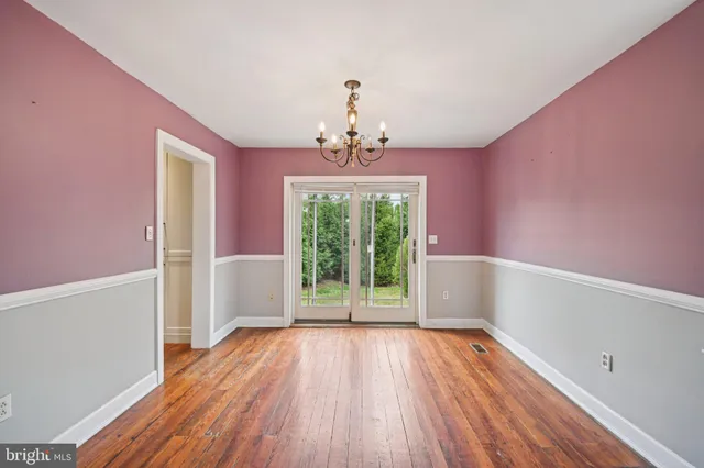 a view of livingroom with hallway and wooden floor