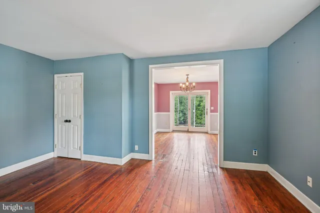 a view of a room with wooden floor and window