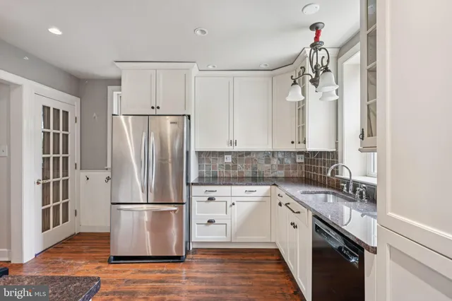 a kitchen with a refrigerator sink and cabinets