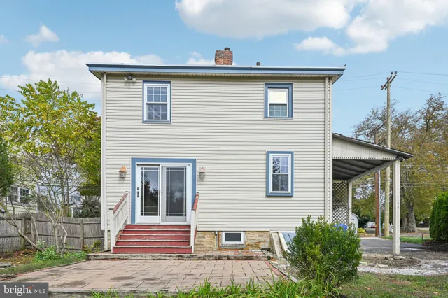 a view of a field with trees in the background