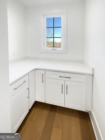 a view of a kitchen with white cabinets