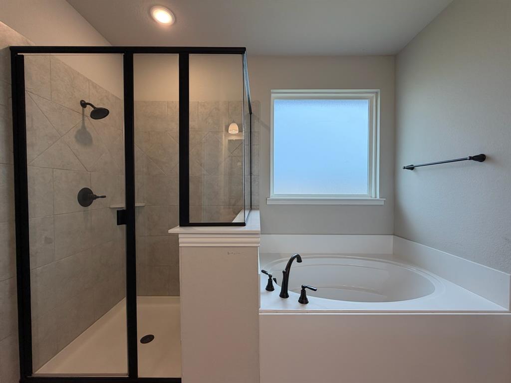 1035 Northern Oaks Court Springtown, TX 76082 - Photo 11 of 15 a bathroom with a bathtub and a shower