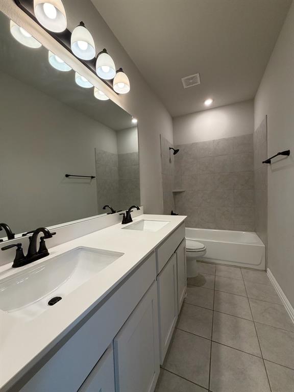 1035 Northern Oaks Court Springtown, TX 76082 - Photo 12 of 15 a bathroom with a sink a toilet a mirror and shower