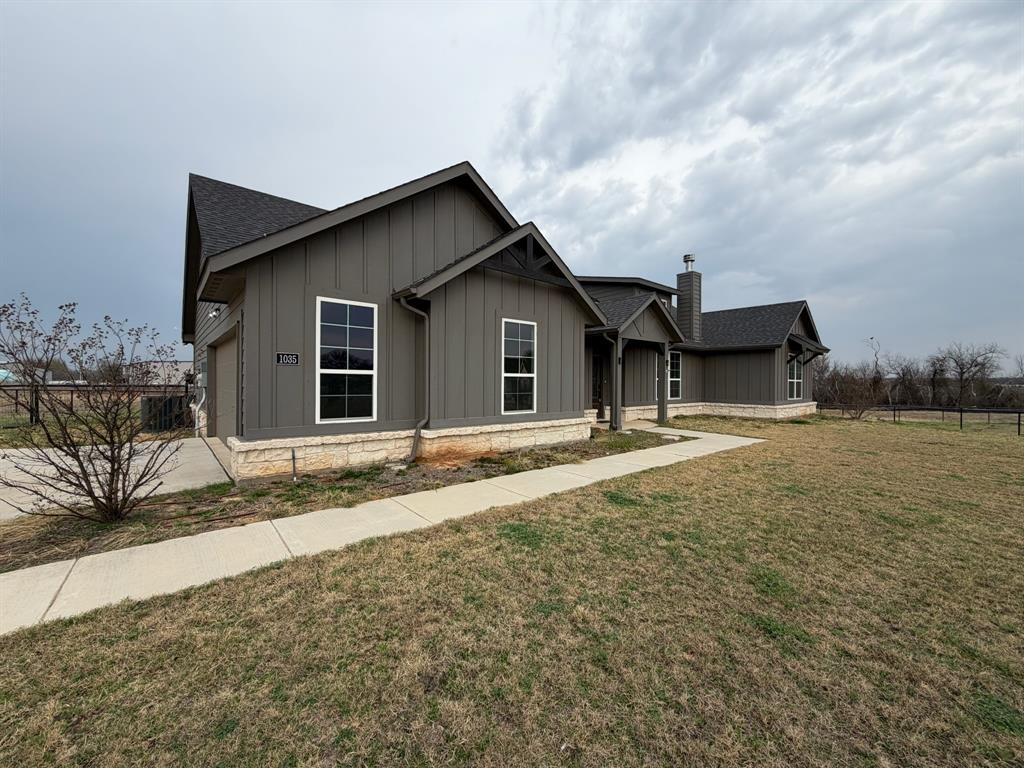 1035 Northern Oaks Court Springtown, TX 76082 - Photo 2 of 15 a house with trees in the background