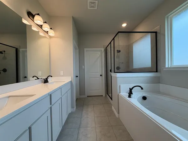 a bathroom with a bathtub and a shower