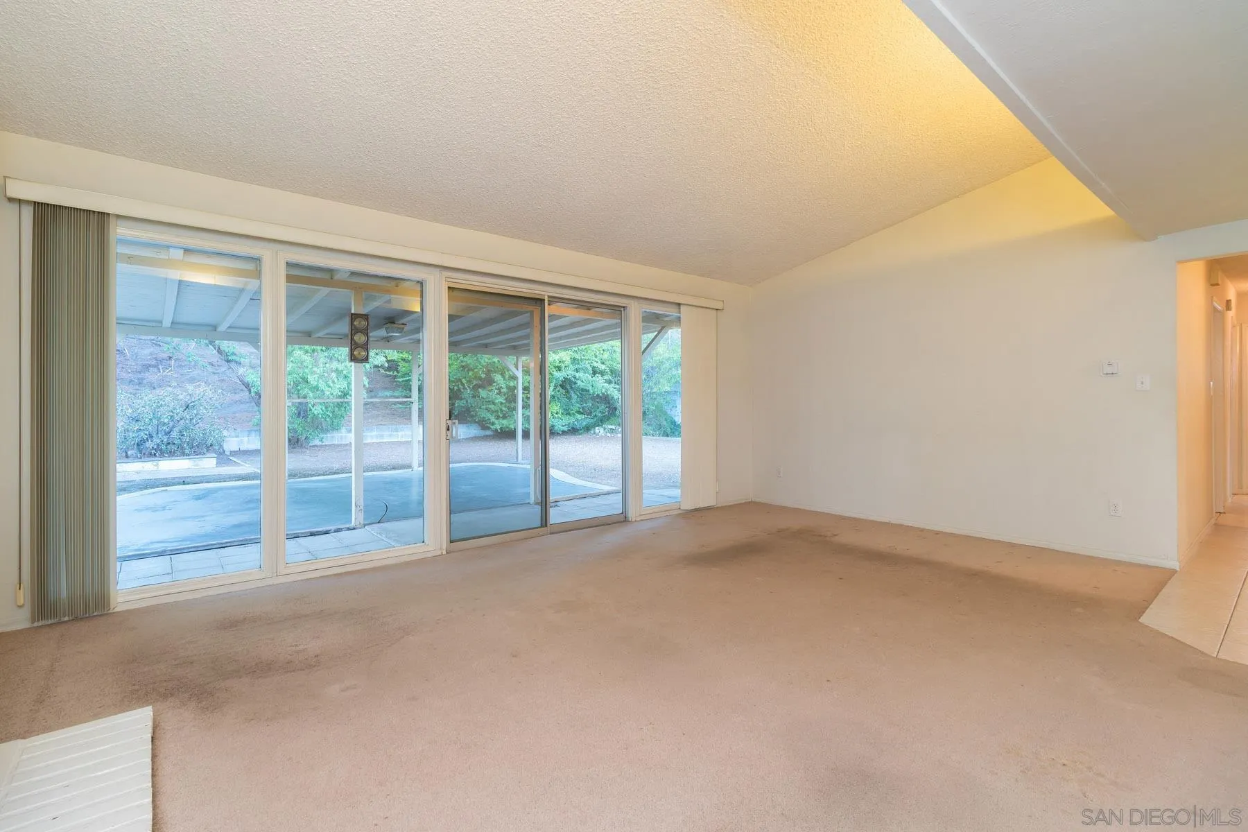14184 Halper Road Poway, CA 92064 - Photo 6 of 20 a view of an empty room with wooden floor and a window