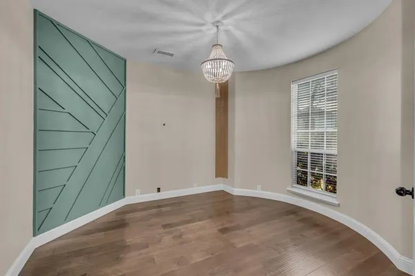 a view of a room with wooden floor and windows