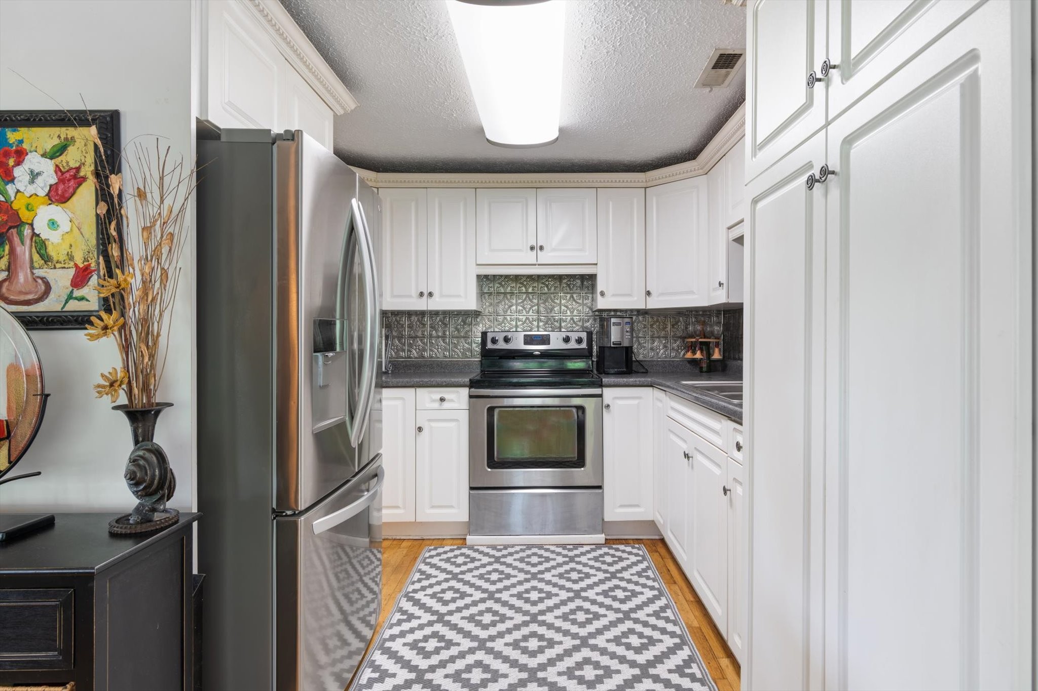 126 Blackey Bandy Road Bethpage, TN 37022 - Photo 10 of 37 a kitchen with stainless steel appliances granite countertop a refrigerator and a stove top oven