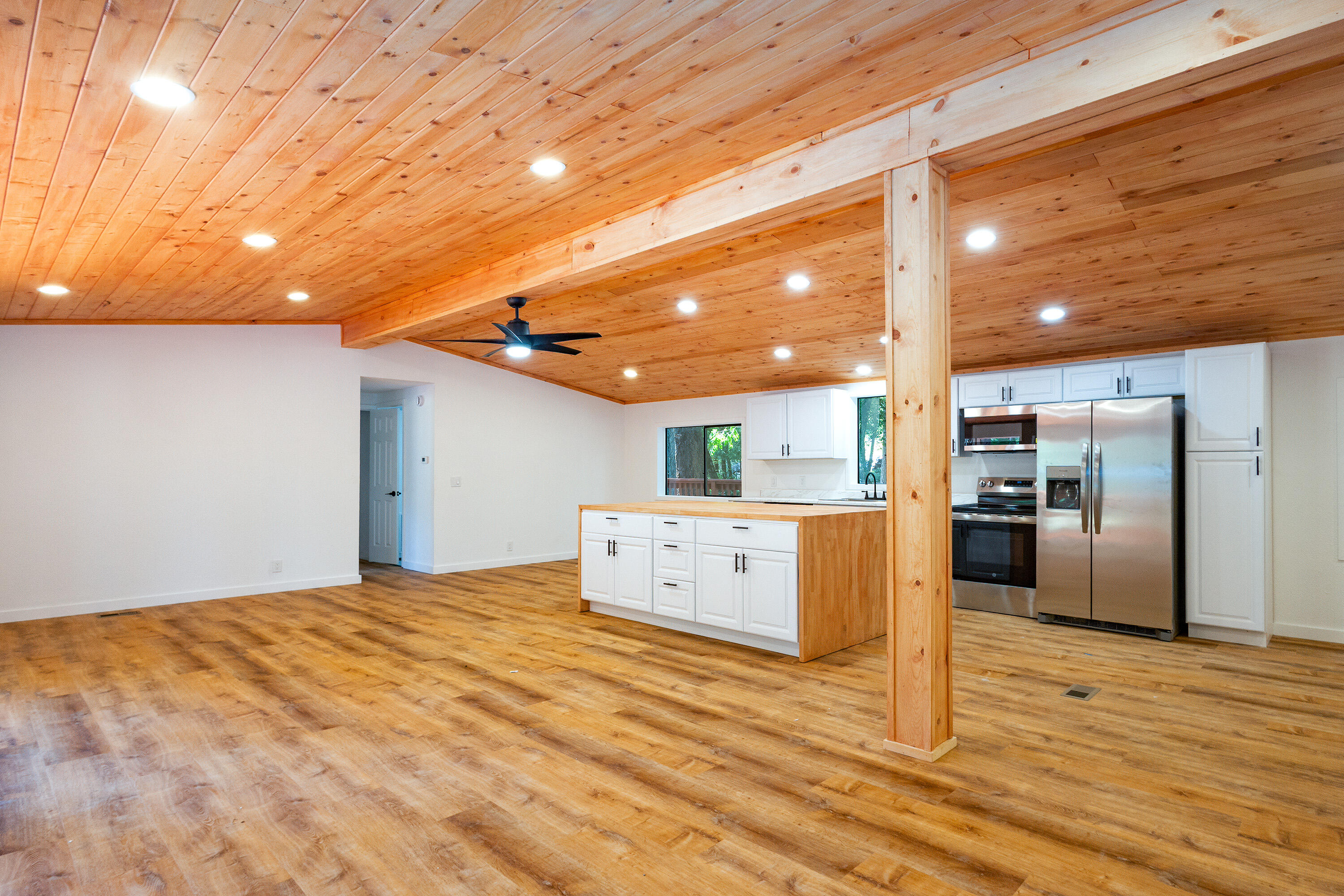 601 Pinewood Way Cave Junction, OR 97523 - Photo 4 of 33 a view of a kitchen with refrigerator and wooden floor