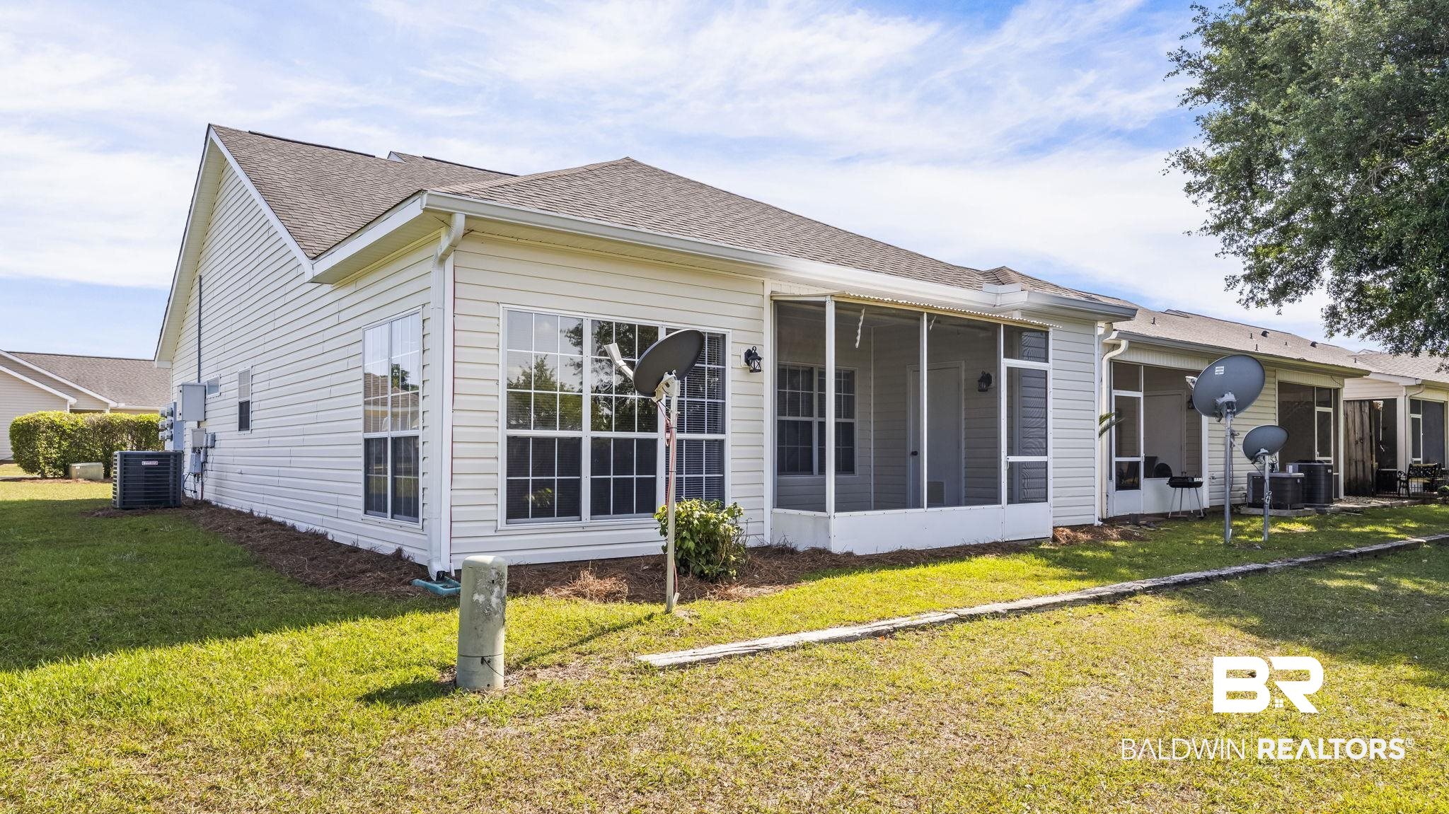 2651 South Juniper Street, Unit 705 Foley, AL 36535 - Photo 26 of 37 Exterior featuring white vinyl siding, multiple large windows, and a screened-in porch