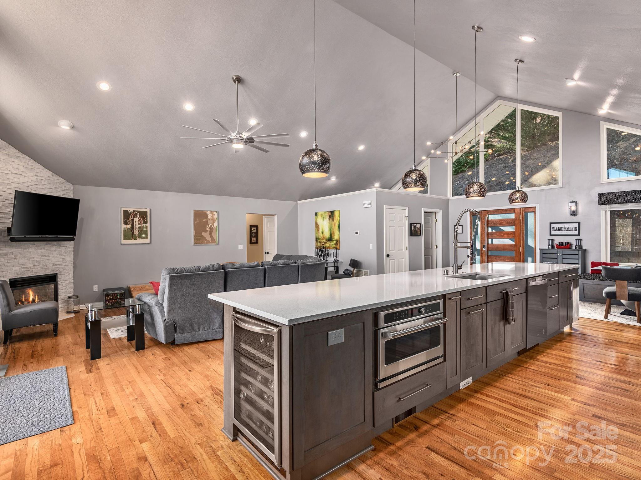 1591 Chestnut Flats Road Waynesville, NC 28786 - Photo 12 of 40 a kitchen with stainless steel appliances granite countertop a sink a stove and a wooden floors