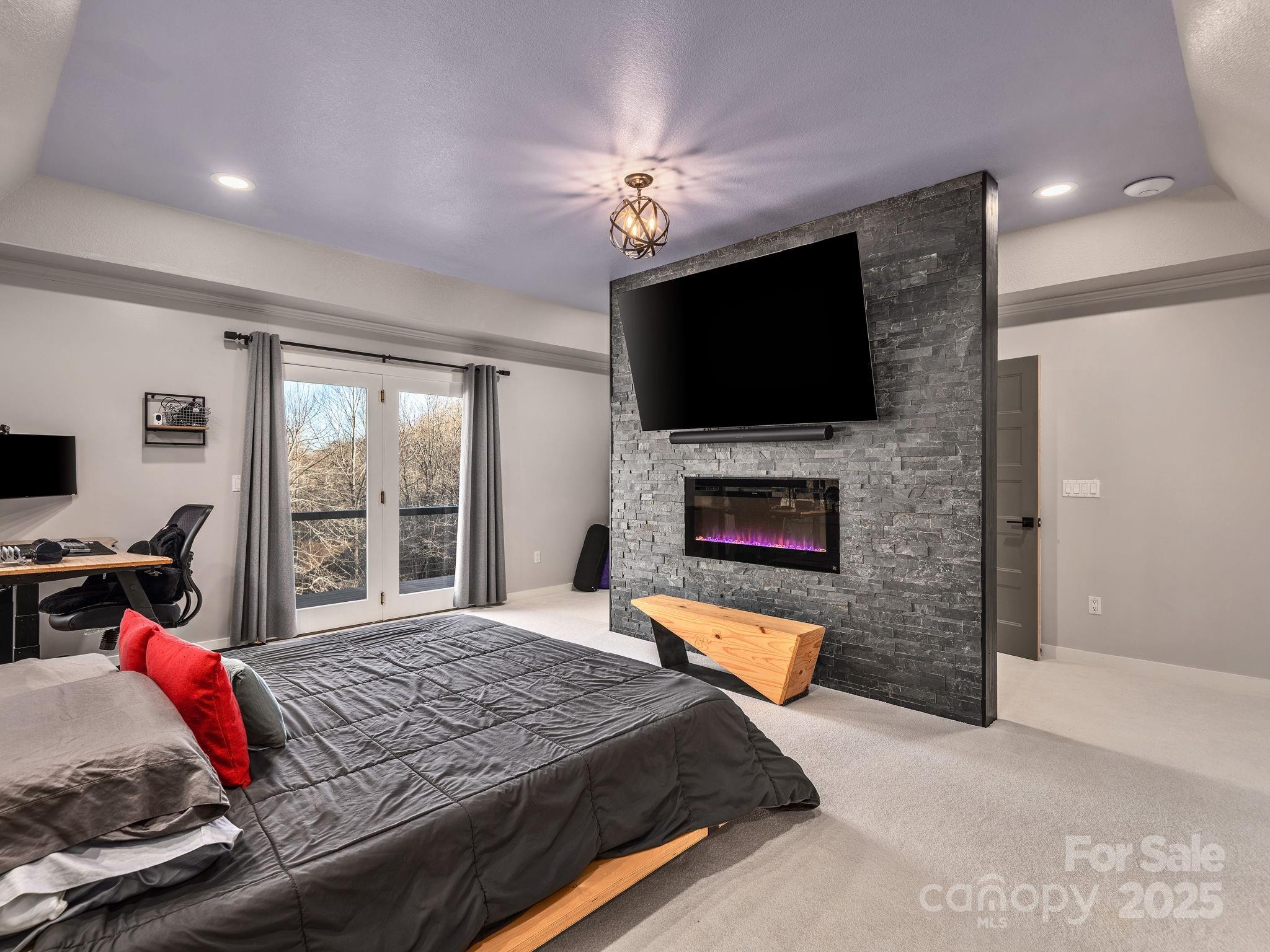 1591 Chestnut Flats Road Waynesville, NC 28786 - Photo 18 of 40 a bedroom with a bed and a flat screen tv