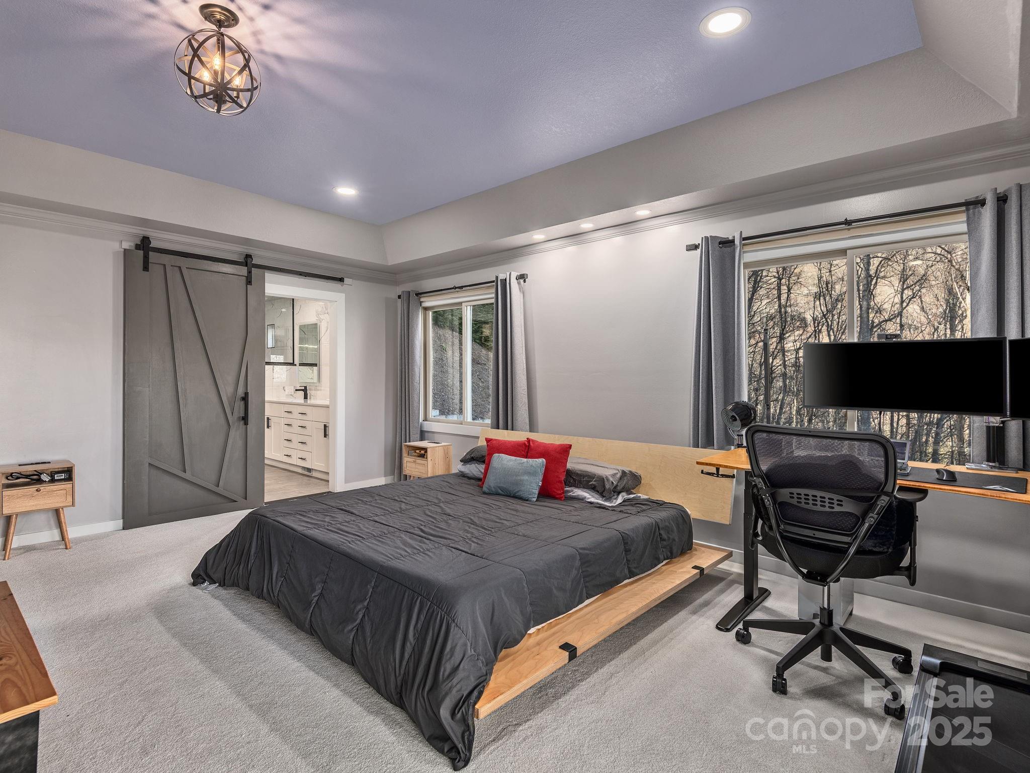 1591 Chestnut Flats Road Waynesville, NC 28786 - Photo 19 of 40 a bedroom with a bed and a flat screen tv