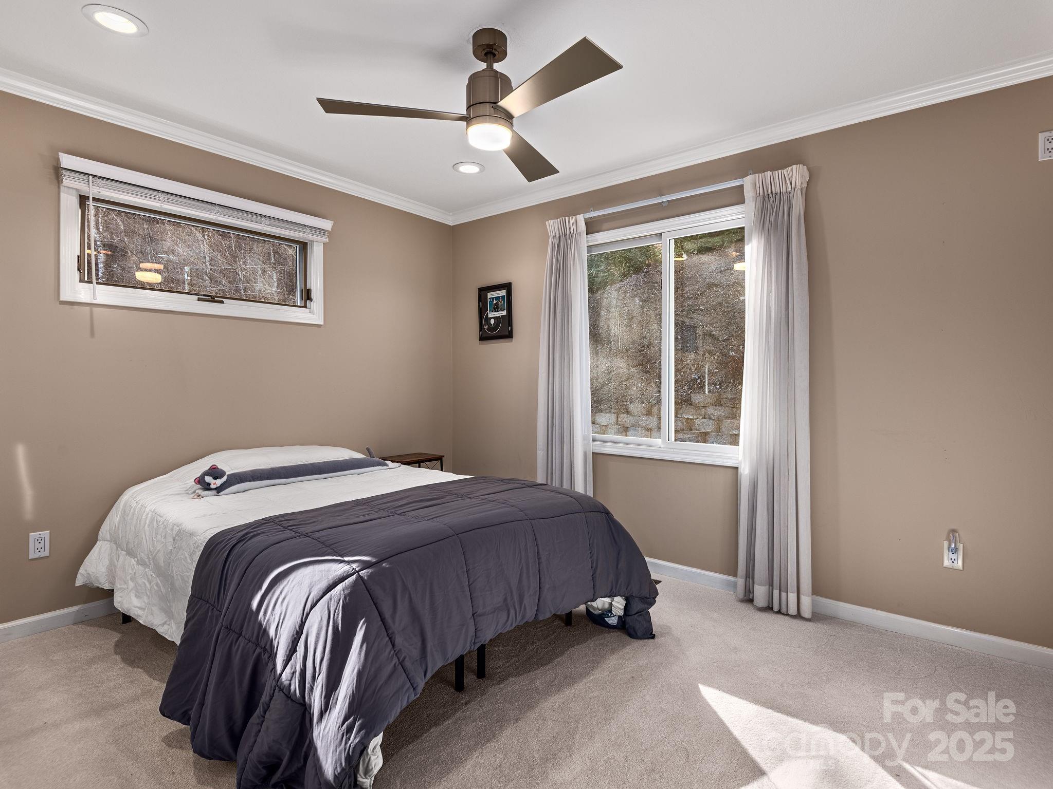 1591 Chestnut Flats Road Waynesville, NC 28786 - Photo 24 of 40 a bedroom with a bed and a window