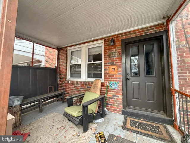 a living room with furniture a flat screen tv and a window