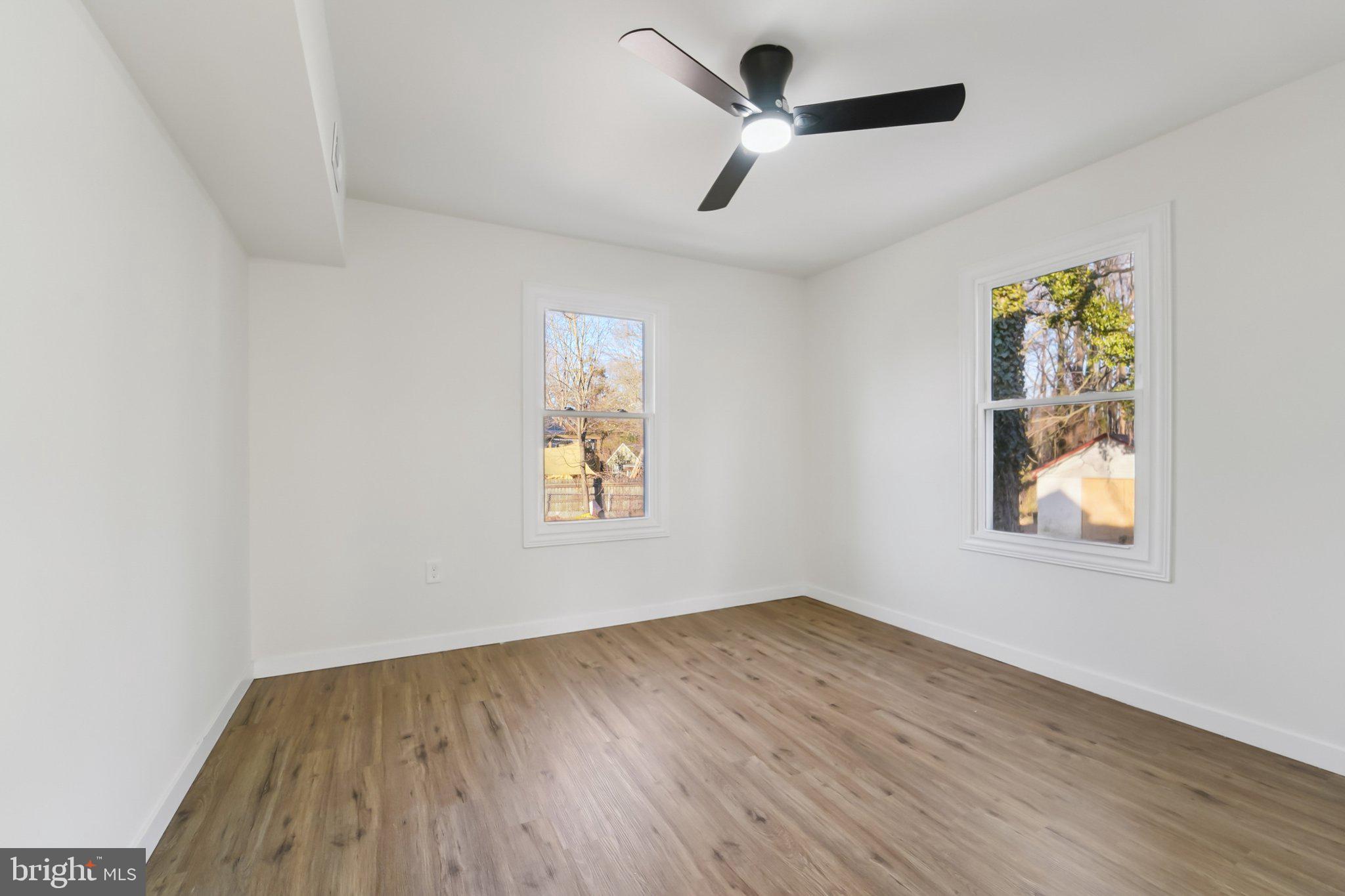 27 Pelczar Avenue Baltimore, MD 21221 - Photo 16 of 40 wooden floor in an empty room with a window