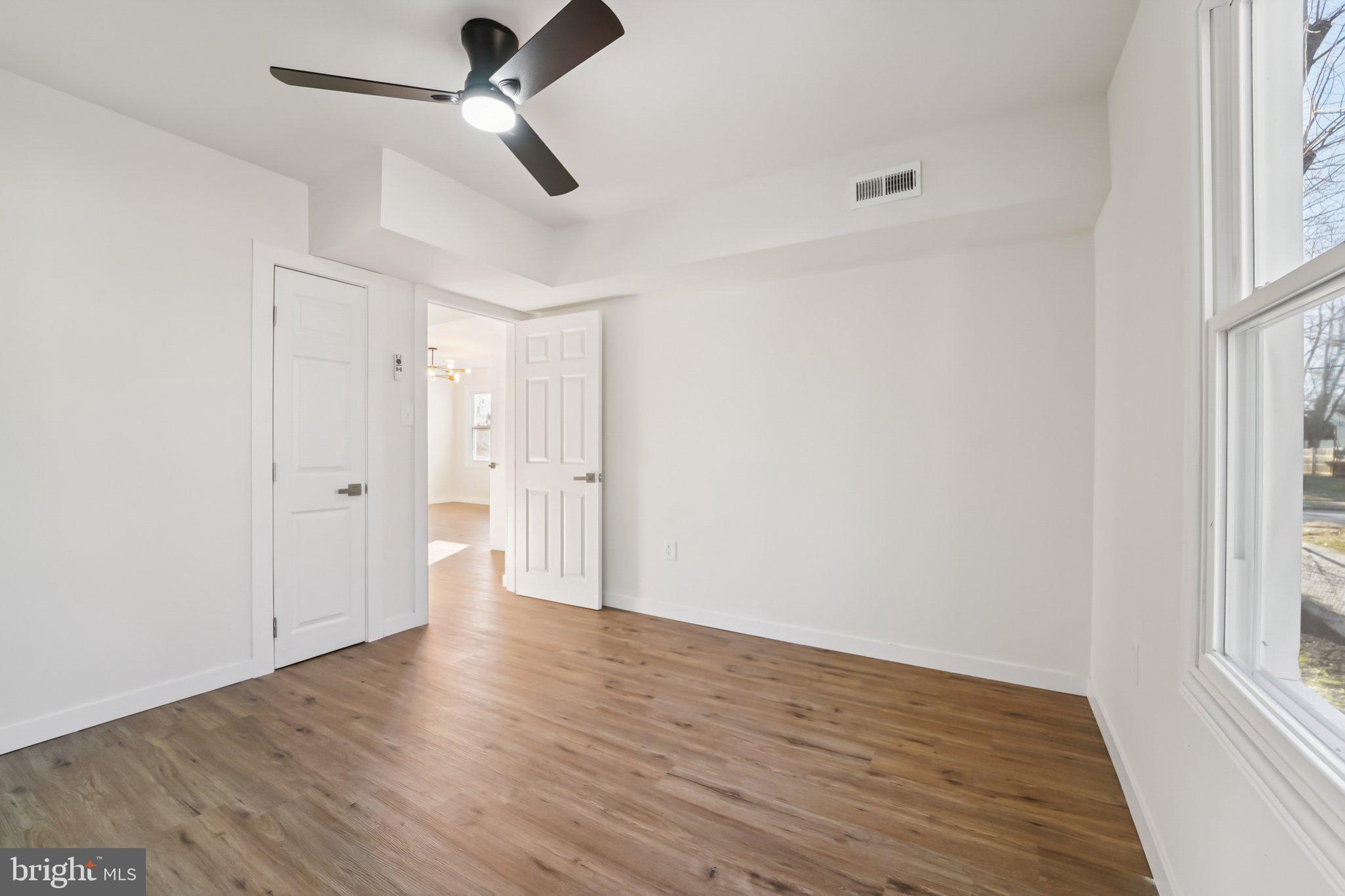 27 Pelczar Avenue Baltimore, MD 21221 - Photo 17 of 40 wooden floor in an empty room with a window