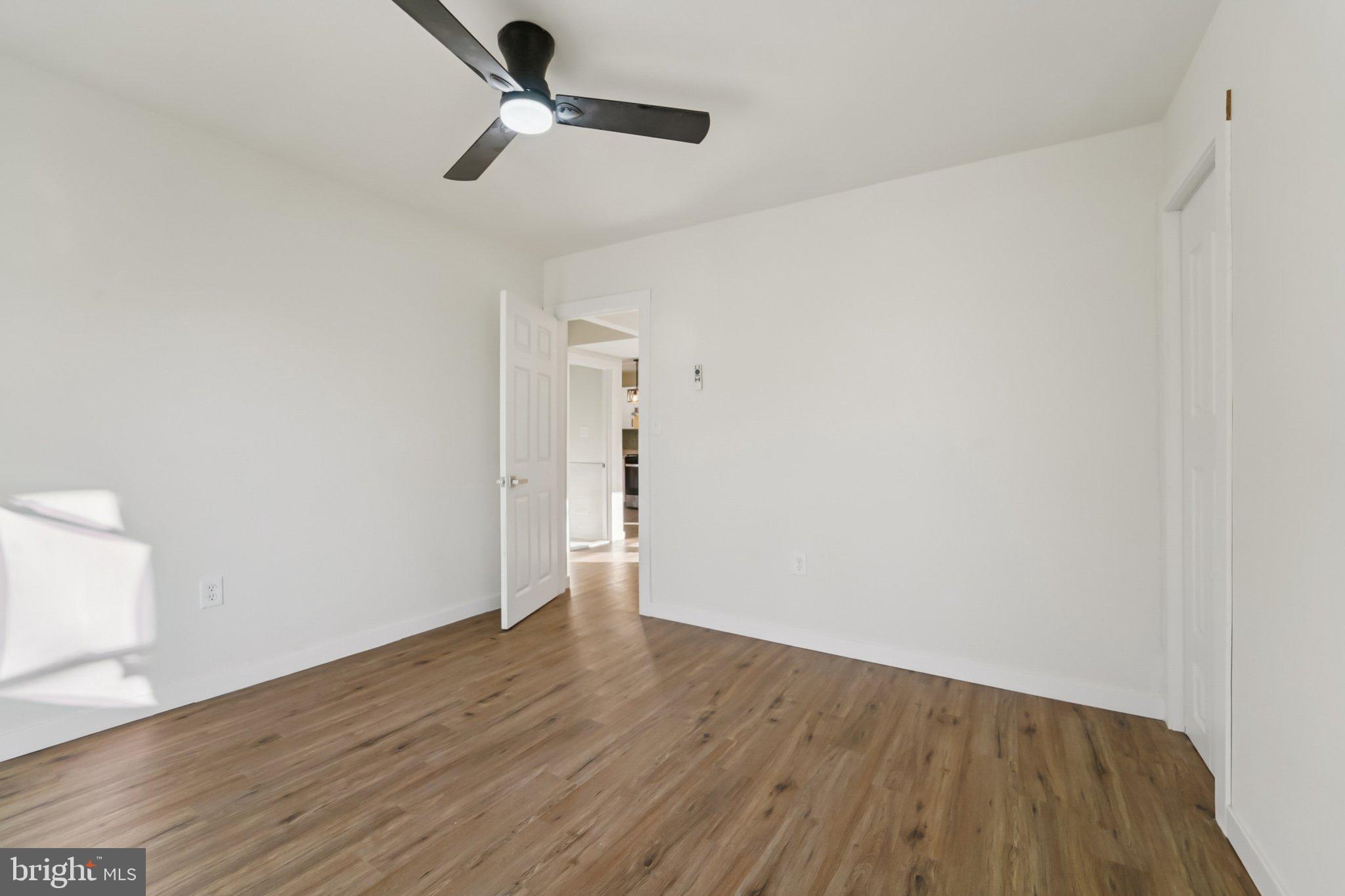 27 Pelczar Avenue Baltimore, MD 21221 - Photo 19 of 40 a view of an empty room with wooden floor