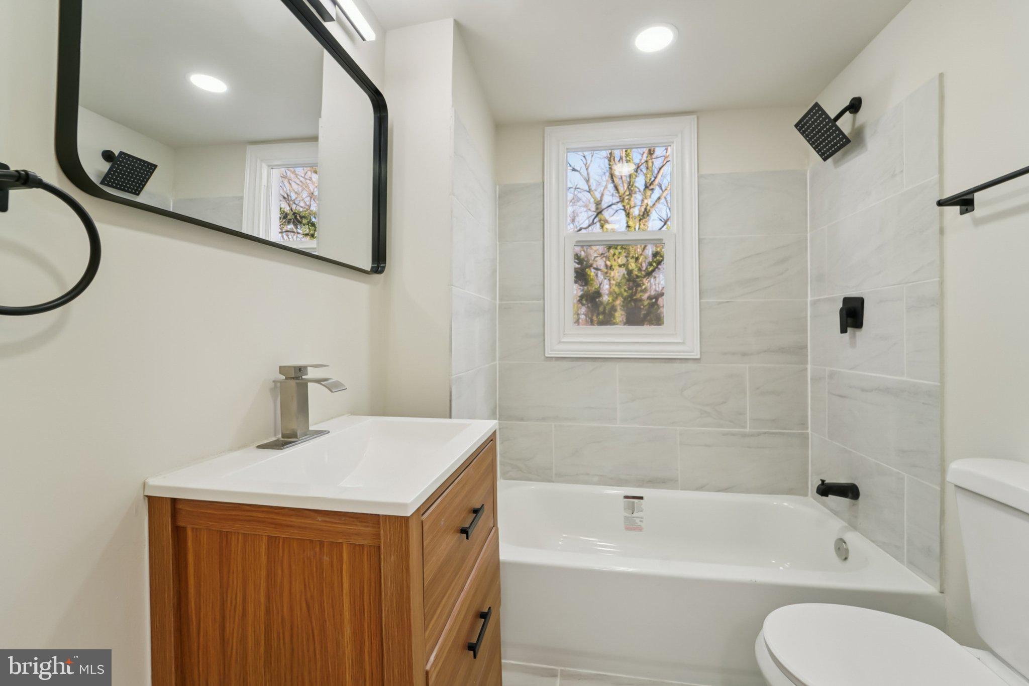 27 Pelczar Avenue Baltimore, MD 21221 - Photo 22 of 40 a bathroom with a sink a toilet and a bathtub