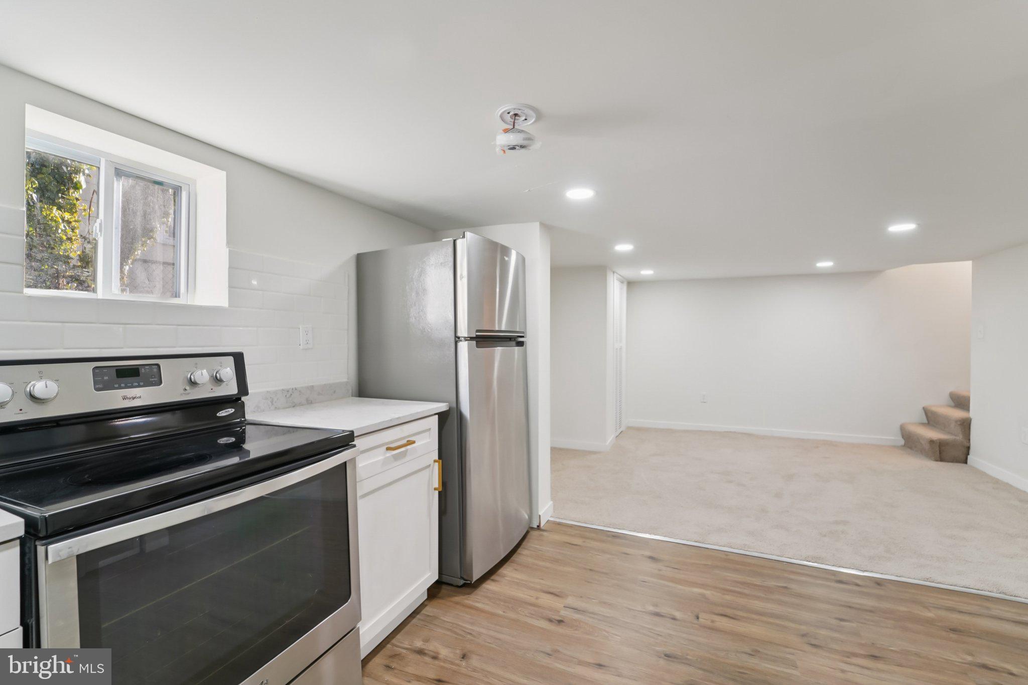 27 Pelczar Avenue Baltimore, MD 21221 - Photo 28 of 40 a kitchen with a stove and a refrigerator