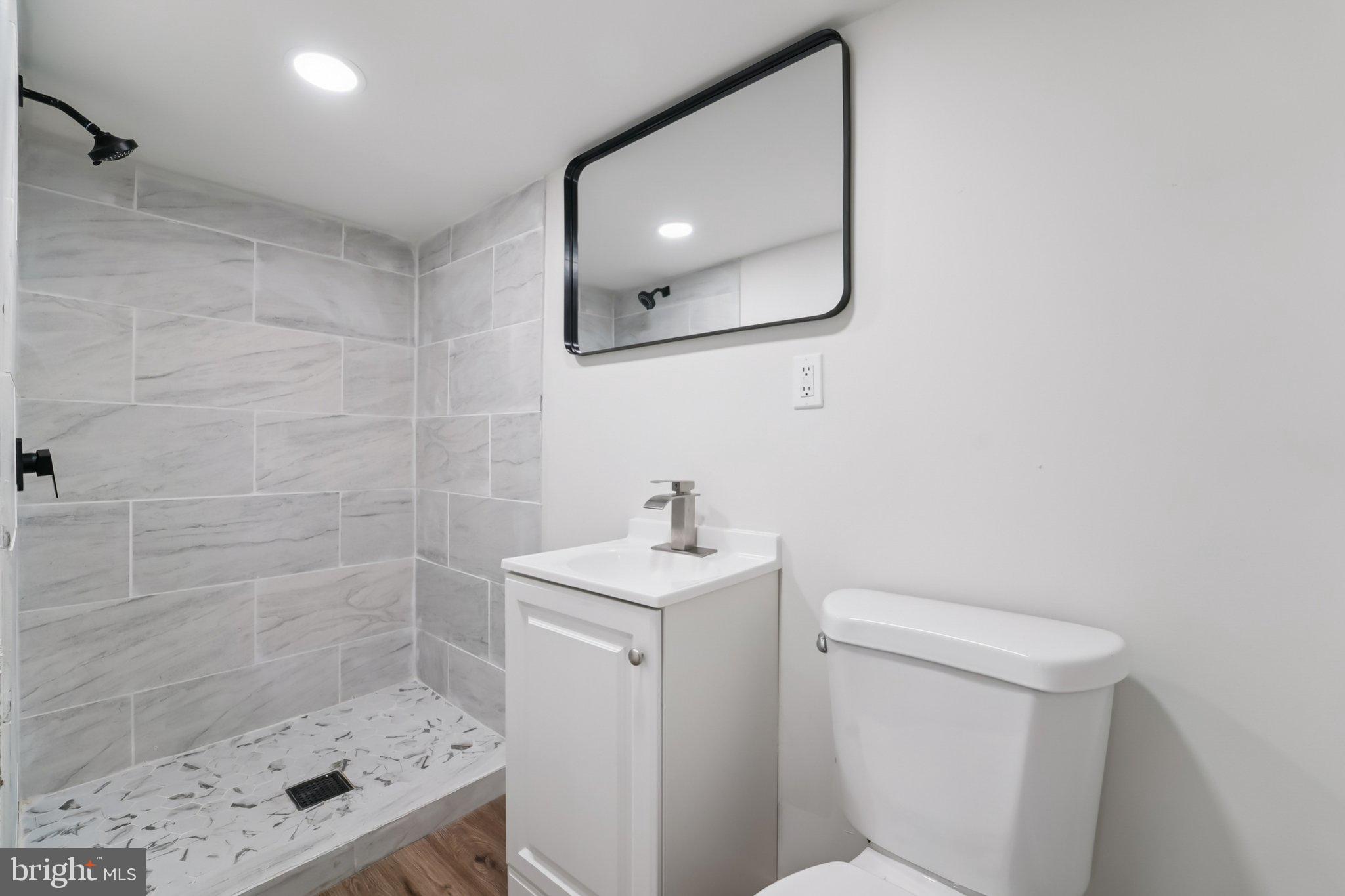 27 Pelczar Avenue Baltimore, MD 21221 - Photo 29 of 40 a bathroom with a sink a toilet and shower