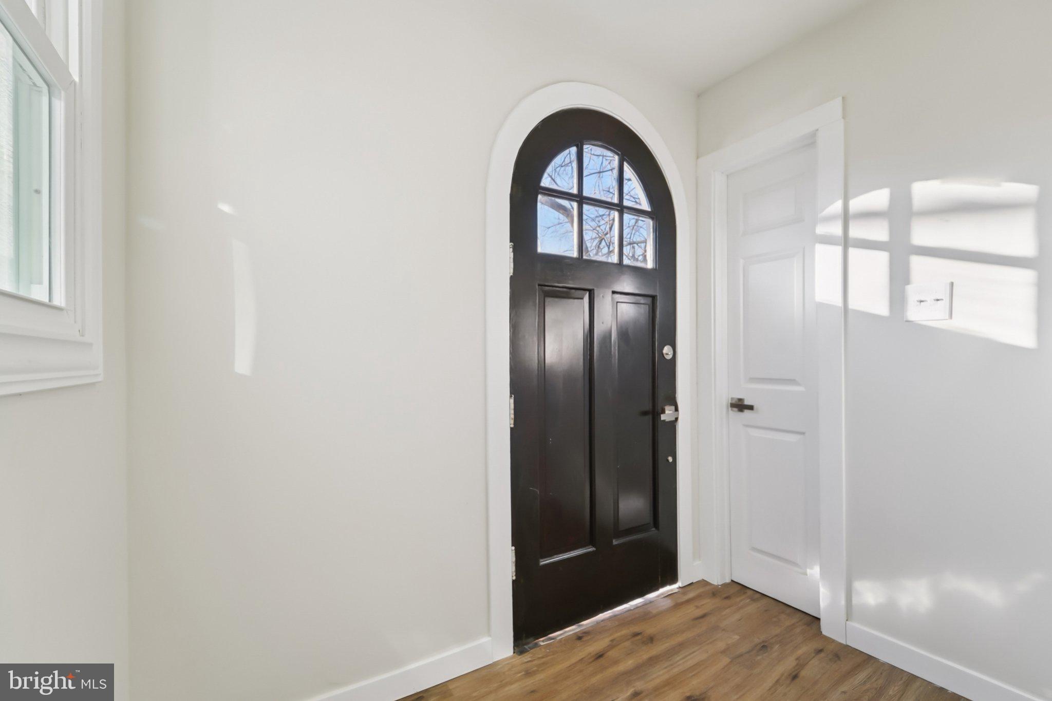 27 Pelczar Avenue Baltimore, MD 21221 - Photo 6 of 40 a view of empty room with wooden floor and fan