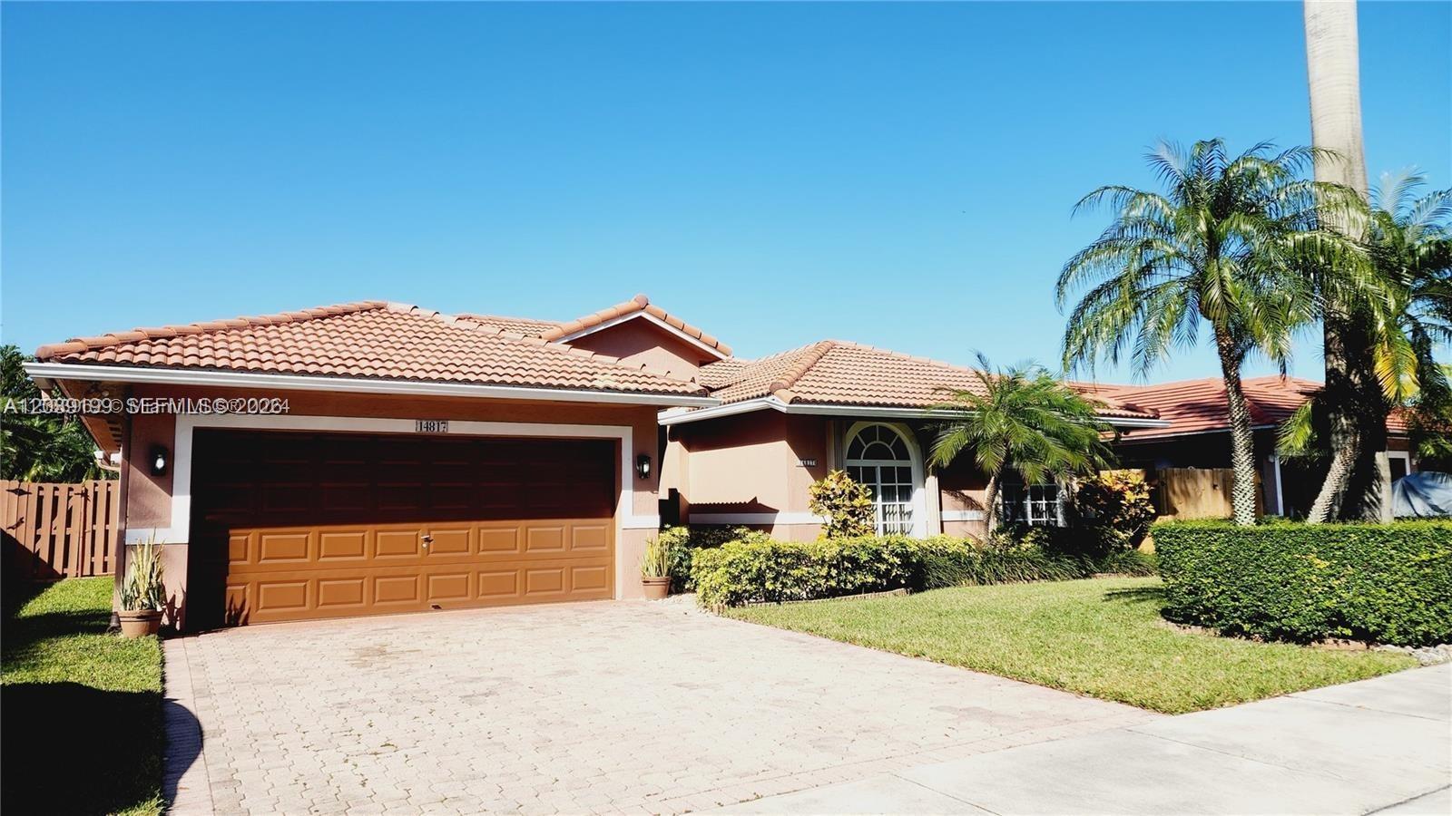 14817 Southwest 180th Street Miami, FL 33187 - Photo 15 of 15 a front view of a house with a yard and garage