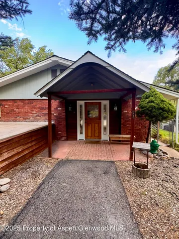 a view of a house with a yard and sitting area