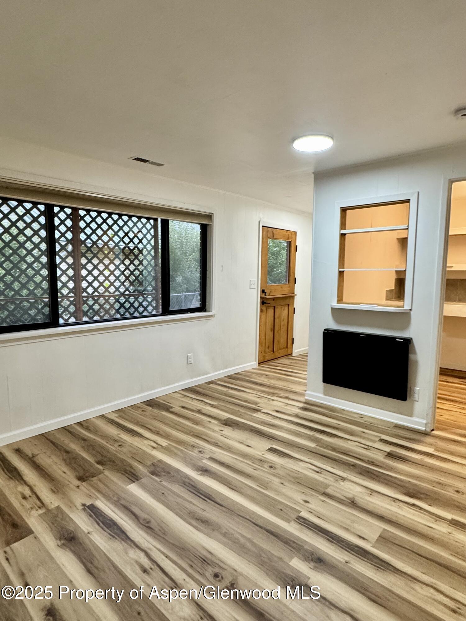 228 North 7th Street New Castle, CO 81647 - Photo 15 of 24 a view of a livingroom with wooden floor and kitchen view