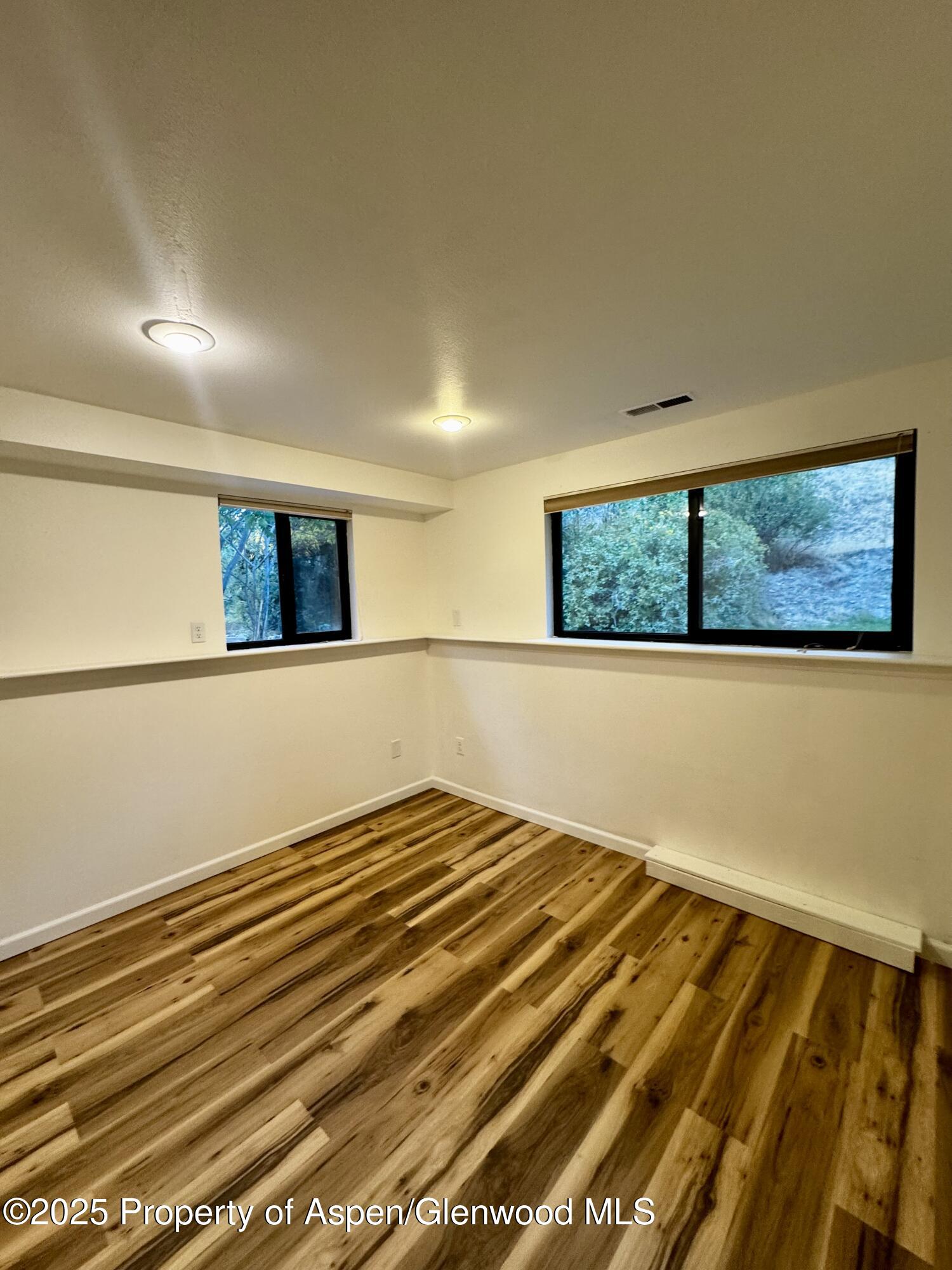 228 North 7th Street New Castle, CO 81647 - Photo 17 of 24 a view of a room with wooden floor and window