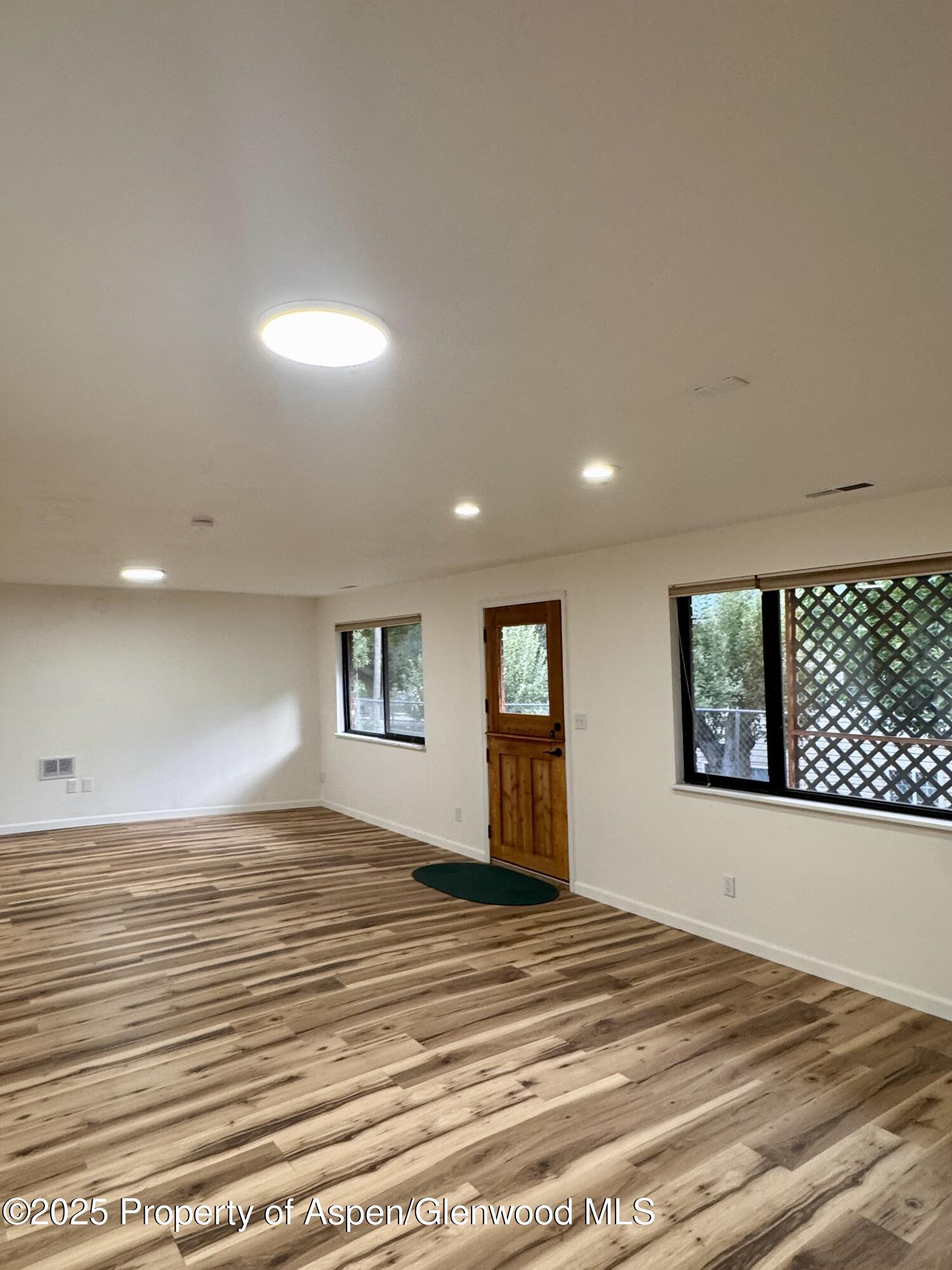 228 North 7th Street New Castle, CO 81647 - Photo 10 of 24 a view of a livingroom with wooden floor and a large window